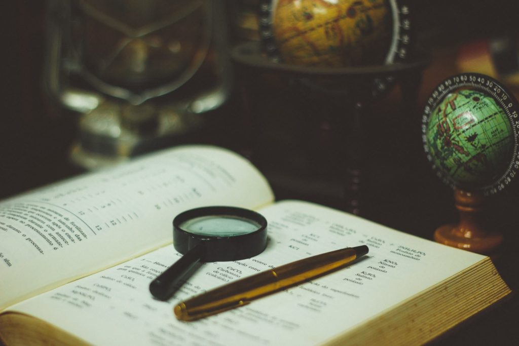 magnifying glass on book inspection analysis