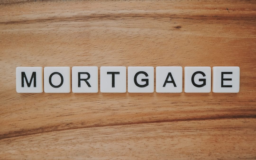 mortgage spelled with scrabble tiles on wood