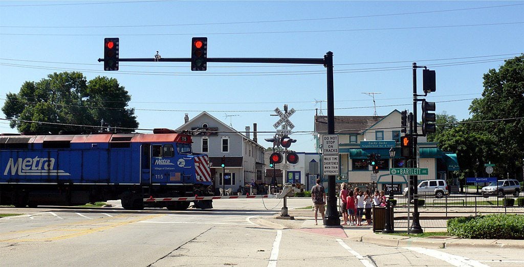 Metra train crossing an intersection at a red light in Bartlett, Illinois