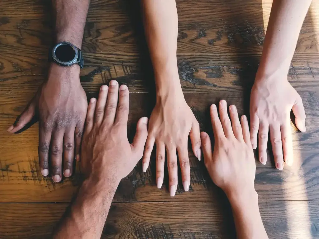 hands of all different cultures and ability men and women